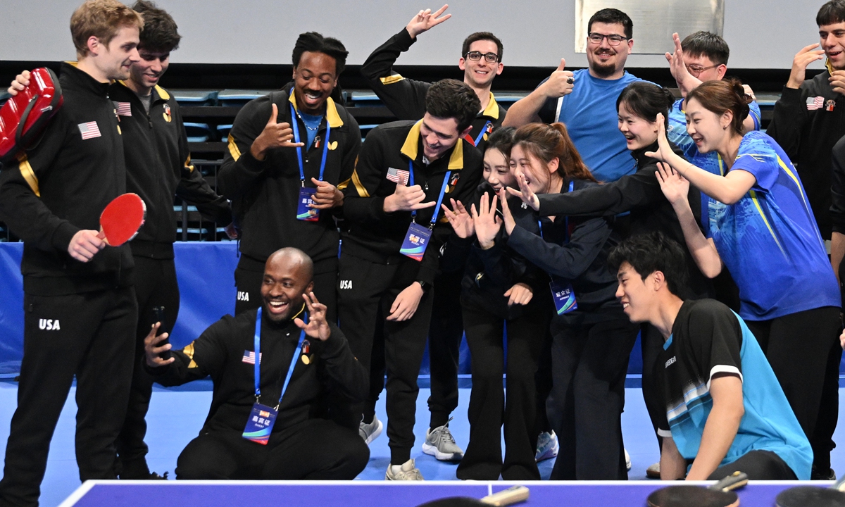 Chinese and American youths shoot interactive videos together in Beijing on April 10, 2026, during the 55th anniversary commemorative event of China-US 