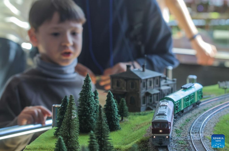 A boy views exhibits during an exhibition of train and railway dioramas in St. Petersburg, Russia, on April 11, 2026. The exhibition kicked off here on Saturday, showcasing over 240 train and railway dioramas from Russia and other countries. The event runs until April 19. (Photo by Irina Motina/Xinhua)