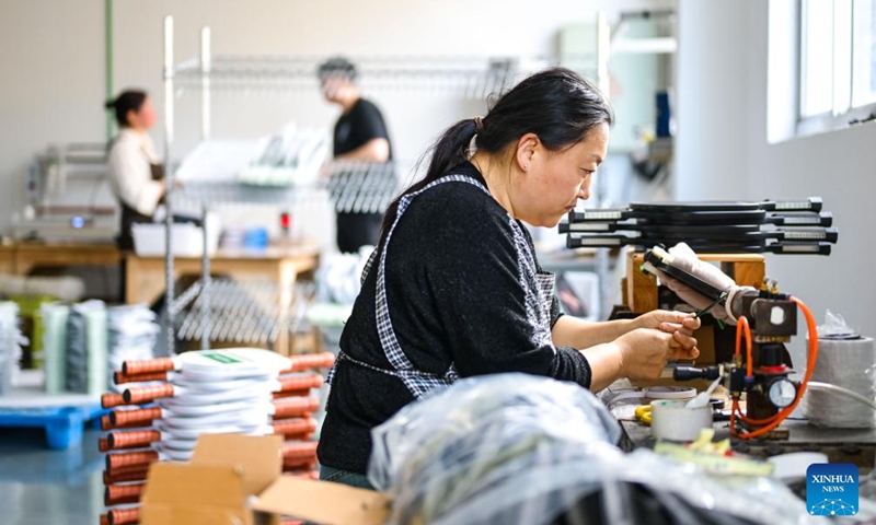 An employee works on a pickleball paddle at a workshop in Linhai, Taizhou City, east China's Zhejiang Province, April 10, 2026. In recent years, Taizhou City has encouraged the cluster development of its sports goods manufacturing industry, forming several clusters including outdoor jackets, outdoor leisure products, sports glasses, and cycling and related outdoor products. (Xinhua/Jiang Han)