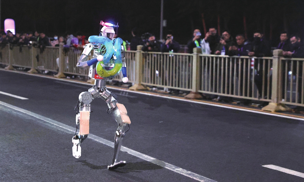 A humanoid robot conducts late-night testing in Beijing on April 11, 2026, as it prepares for the upcoming half marathon event held in the city. Photo: VCG
