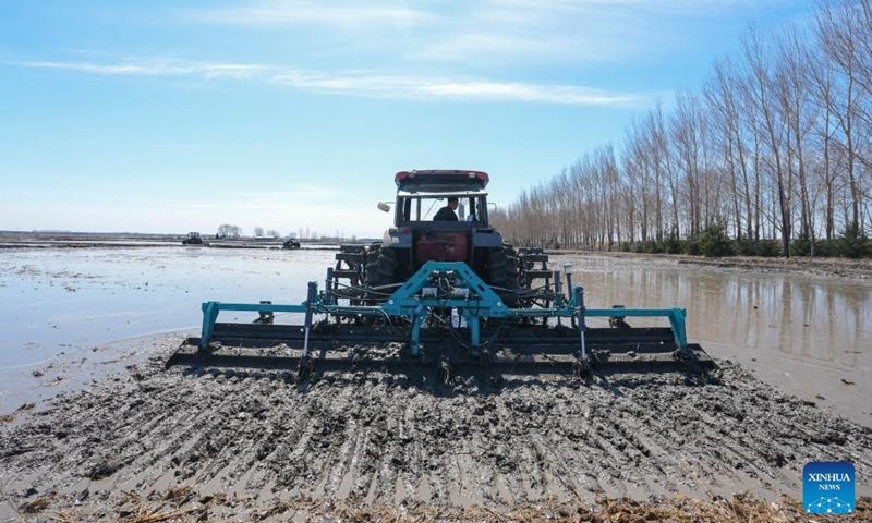 A drone photo taken on April 9, 2026 shows a farming machine ploughing a paddy field of Youyi Farm Co., Ltd. under Beidahuang Group in Shuangyashan, northeast China's Heilongjiang Province. Heilongjiang, a major grain-producing area in China, has entered the spring ploughing season for rice. (Xinhua/Wang Song)