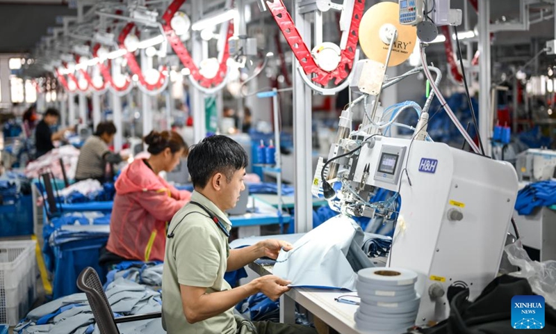 Employees work at a workshop of an enterprise in Sanmen County of Taizhou City, east China's Zhejiang Province, April 10, 2026. In recent years, Taizhou City has encouraged the cluster development of its sports goods manufacturing industry, forming several clusters including outdoor jackets, outdoor leisure products, sports glasses, and cycling and related outdoor products. (Xinhua/Jiang Han)