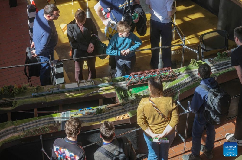 People view exhibits during an exhibition of train and railway dioramas in St. Petersburg, Russia, on April 11, 2026. The exhibition kicked off here on Saturday, showcasing over 240 train and railway dioramas from Russia and other countries. The event runs until April 19. (Photo by Irina Motina/Xinhua)