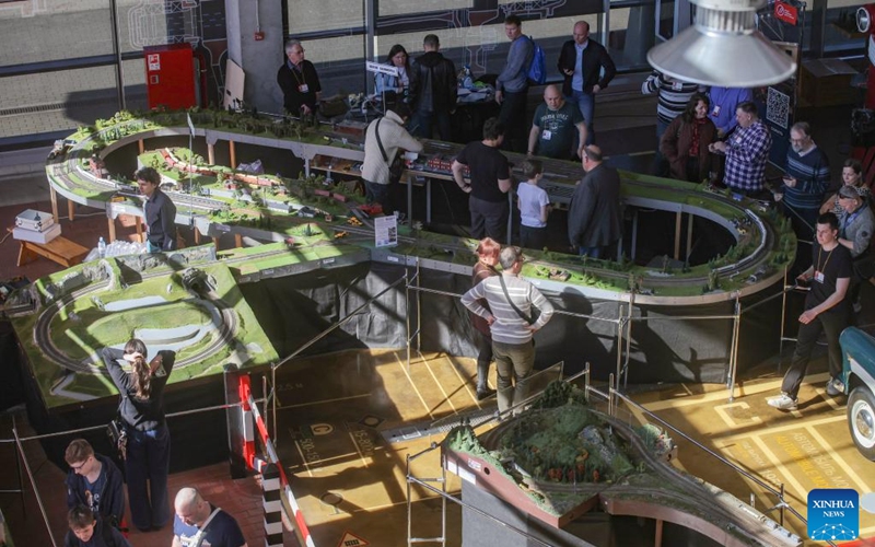People attend an exhibition of train and railway dioramas in St. Petersburg, Russia, on April 11, 2026. The exhibition kicked off here on Saturday, showcasing over 240 train and railway dioramas from Russia and other countries. The event runs until April 19. (Photo by Irina Motina/Xinhua)