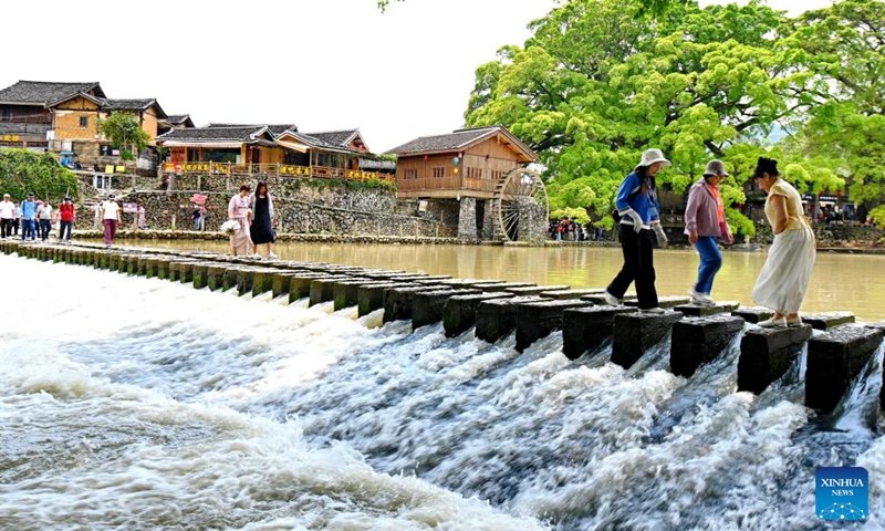 Tourists visit Yunshuiyao ancient town in Nanjing County, southeast China's Fujian Province, April 9, 2026. Tulou, the unique residential architecture of Fujian Province, was inscribed on the UNESCO's World Heritage List in 2008. In recent years, local authorities has continued promoting Tulou protection, revitalization, and integration with tourism. (Xinhua/Lin Shanchuan)