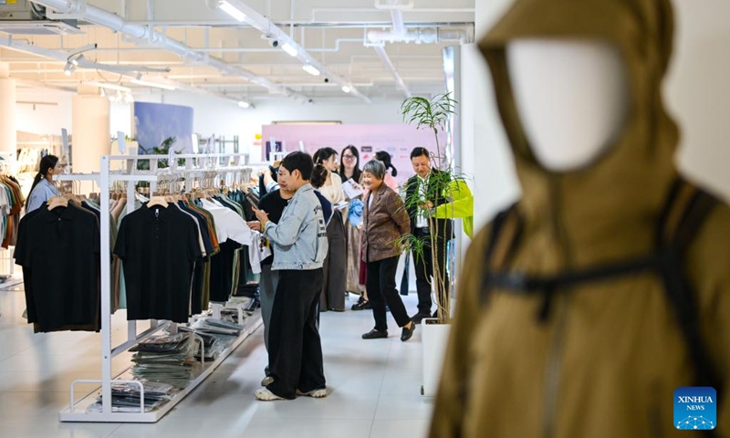 People shop at a display hall of an enterprise in Sanmen County of Taizhou City, east China's Zhejiang Province, April 10, 2026. In recent years, Taizhou City has encouraged the cluster development of its sports goods manufacturing industry, forming several clusters including outdoor jackets, outdoor leisure products, sports glasses, and cycling and related outdoor products. (Xinhua/Jiang Han)