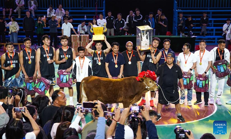 Winners team Kaili celebrate with an ox as the prize after the final match between Kaili City and Yanhe County at the 2026 China's Village Basketball Competition in Taipan Village, Taijiang County, southwest China's Guizhou Province, April 11, 2026. (Xinhua/Yang Wenbin)