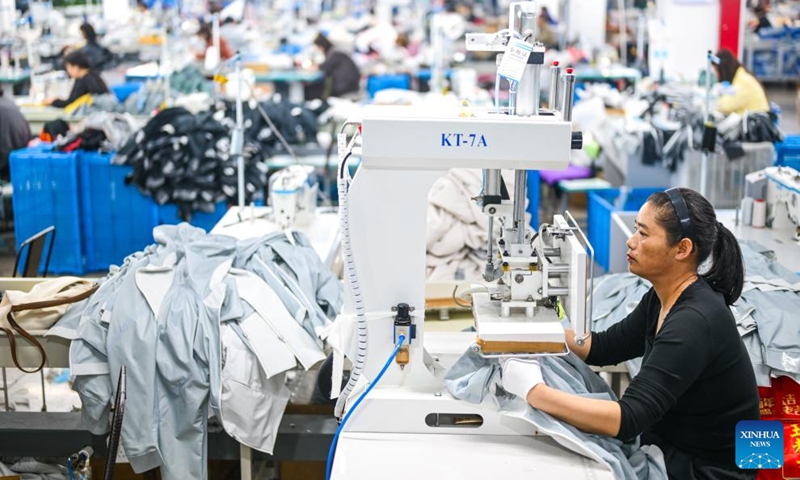 An employee works at a workshop of an enterprise in Sanmen County of Taizhou City, east China's Zhejiang Province, April 10, 2026. In recent years, Taizhou City has encouraged the cluster development of its sports goods manufacturing industry, forming several clusters including outdoor jackets, outdoor leisure products, sports glasses, and cycling and related outdoor products. (Xinhua/Jiang Han)