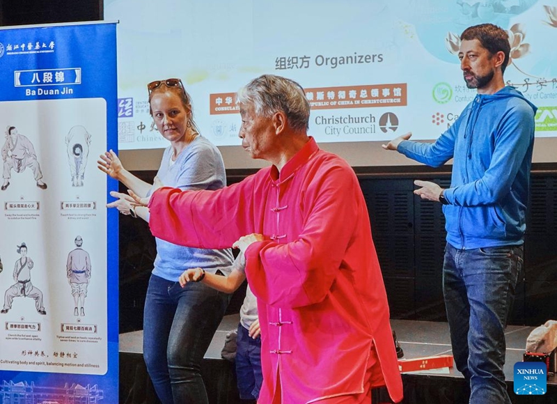 Visitors learn Baduanjin, a traditional Chinese breathing and stretching exercise, at the Chinese + TCM South Island Roadshow in Christchurch, New Zealand, April 11, 2026. The Chinese + TCM (traditional Chinese medicine) South Island Roadshow was held here on Saturday. A team from Zhejiang Chinese Medical University engaged local audiences with lectures, interactive demonstrations and hands-on activities during the event. (Photo by Chen Siyumeng/Xinhua)