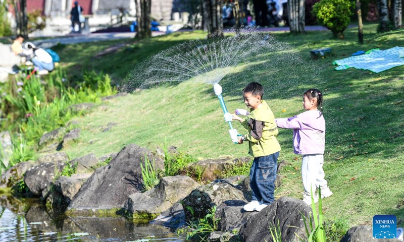 Children enjoy their leisure time at Yudaihe park in southwest China's Chongqing, April 11, 2026. (Xinhua/Tang Yi)