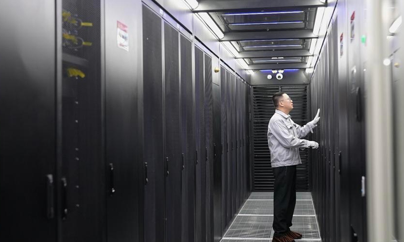 A staff member maintains equipment at the Horinger data center cluster in Hohhot, north China's Inner Mongolia Autonomous Region, May 20, 2025. (Photo by Su Yali/Xinhua)