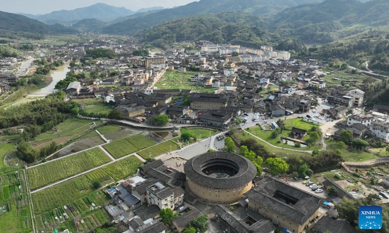 An aerial drone photo taken on April 9, 2026 shows tourists visiting Nanjing County, southeast China's Fujian Province. Tulou, the unique residential architecture of Fujian Province, was inscribed on the UNESCO's World Heritage List in 2008. In recent years, local authorities has continued promoting Tulou protection, revitalization, and integration with tourism. (Xinhua/Lin Shanchuan)