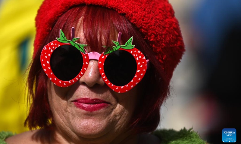 A woman wearing a pair of strawberry-shaped sunglasses is pictured during the strawberry festival in Mgarr, Malta, April 12, 2026. Malta held its annual strawberry festival in Mgarr on Sunday. (Photo by Jonathan Borg/Xinhua)