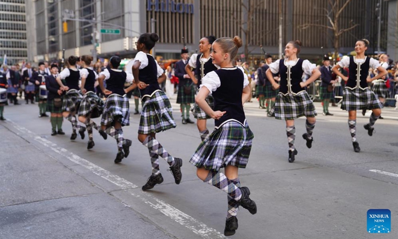 Participants dance during the annual Tartan Day Parade in New York, the United States, on April 11, 2026. More than 3,000 bagpipers, highland dancers and other participants marched to celebrate the annual Tartan Day here on Saturday. The event was held to mark the existing and historical links between Scotland and Scottish descendants in the U.S.. (Xinhua/Zhang Fengguo)