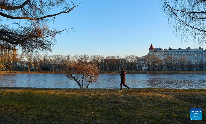 A woman jogs on Yelagin Island in St. Petersburg, Russia, April 11, 2026. Located in the northwest of St. Petersburg, Yelagin Island was once a royal garden and is now a famous tourist and leisure destination. (Photo by Guo Feizhou/Xinhua)
