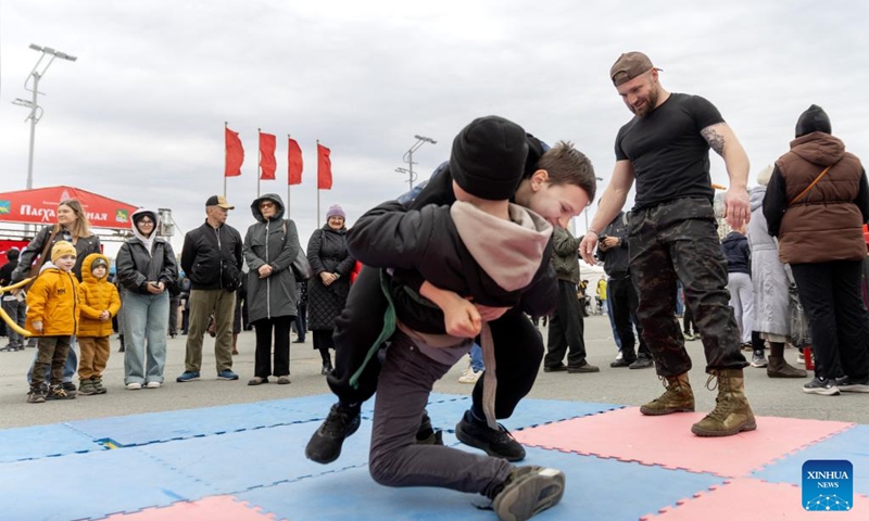 Children participate in a wrestling game in Vladivostok, Russia, April 12, 2026. Various recreational activities were hosted on Sunday to mark the Orthodox Easter holiday. (Photo by Andrey Matveenko/Xinhua)