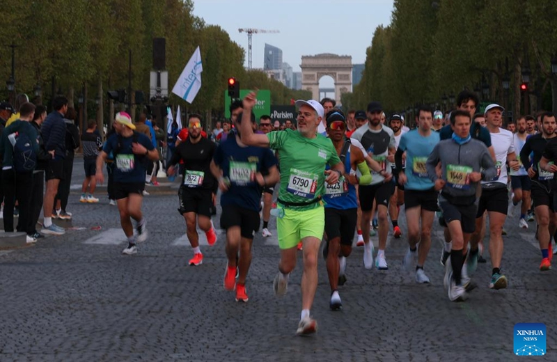 Participants run across Champs-Elysees Avenue during the Paris Marathon 2026 in Paris, France, April 12, 2026. (Xinhua/Wu Huiwo)