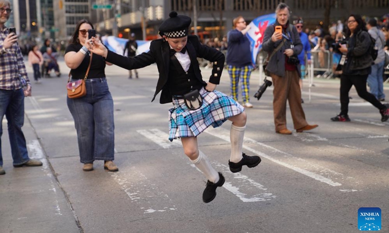 A boy dances during the annual Tartan Day Parade in New York, the United States, on April 11, 2026. More than 3,000 bagpipers, highland dancers and other participants marched to celebrate the annual Tartan Day here on Saturday. The event was held to mark the existing and historical links between Scotland and Scottish descendants in the U.S.. (Xinhua/Zhang Fengguo)