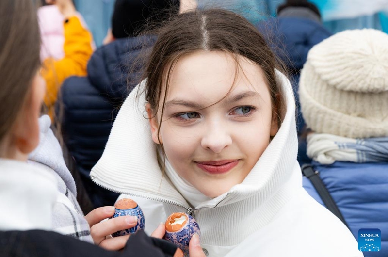 A woman holds Easter eggs while participating in Easter celebrations in Vladivostok, Russia, April 12, 2026. Various recreational activities were hosted on Sunday to mark the Orthodox Easter holiday. (Photo by Andrey Matveenko/Xinhua)