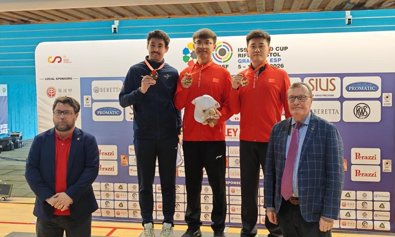 Zhang Changhong (C) and Liu Yukun (2nd R) pose on the podium after the men's 50-meter rifle 3 positions at the ISSF World Cup, in Granada, Spain, on April 12, 2026. (Xinhua)