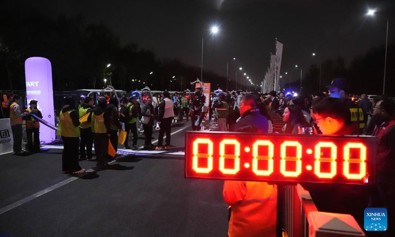 Teams prepare at the start area before the test activity for the 2026 Beijing E-Town Humanoid Robot Half Marathon on April 11, 2026. A full-process and comprehensive testing activity for the Beijing E-Town humanoid robot half-marathon, scheduled for April 19, 2026, was carried out from Saturday night to early Sunday morning. (Xinhua/Xie Han)