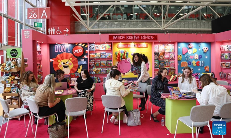 Exhibitors communicate with visitors during the 63rd Bologna Children's Book Fair in Bologna, Italy, April 13, 2026. The 63rd Bologna Children's Book Fair opened on Monday in the Italian city of Bologna. (Xinhua/Wang Kaiyan)

