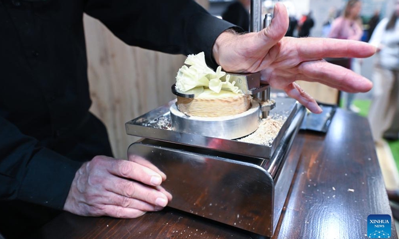An exhibitor makes samples of cheese during the Salon Gourmets in Madrid, Spain, on April 13, 2026. The 39th Salon Gourmets will run in Madrid from April 13 to 16. (Photo by Gustavo Valiente/Xinhua)