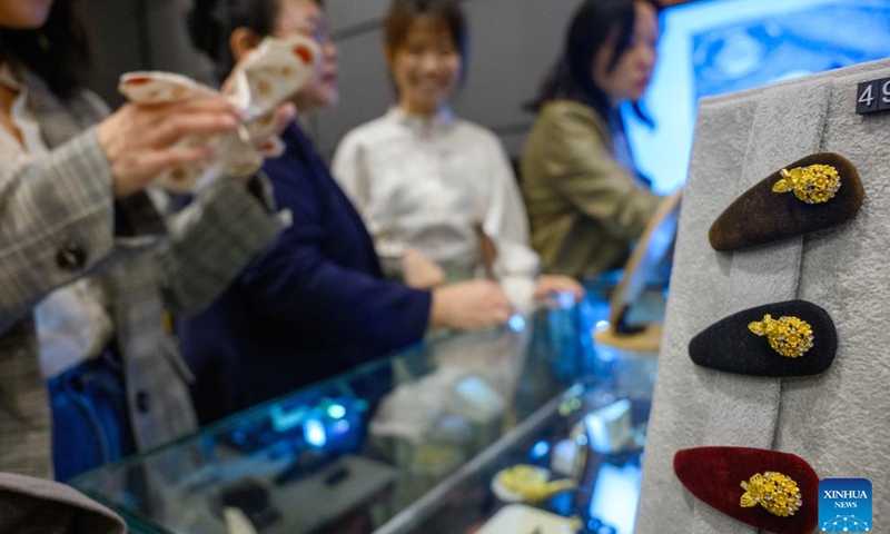 Visitors purchase cultural and creative products of the exhibition A Glimpse into 6th-7th Century China: Discoveries at Li Jingxun's Tomb at the National Museum of China in Beijing, capital of China, April 13, 2026. The ongoing exhibition features relics unearthed from the tomb of Li Jingxun, a young princess who died in 608, and recently discovered key relics from the Northern and Southern Dynasties (420-589) to the Sui Dynasty (581-618). (Xinhua/Jin Liangkuai)