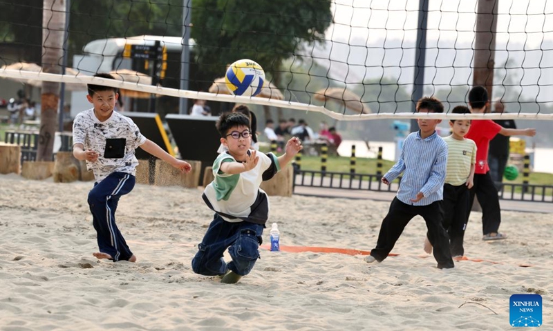 Children play beach volleyball in the Long Jiang Years tourist area in Zhangzhou City, southeast China's Fujian Province, on April 11, 2026.

