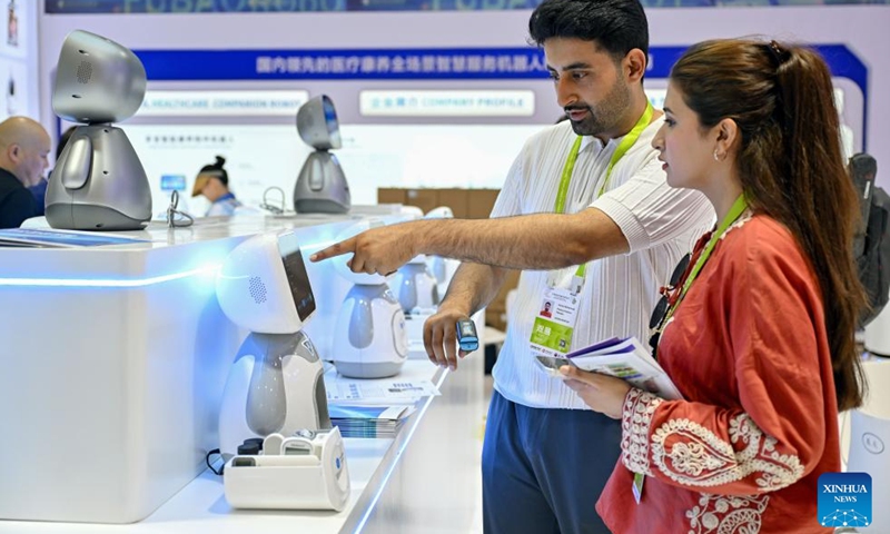 People learn about robot products during the sixth China International Consumer Products Expo (CICPE) in Haikou, south China's Hainan Province, April 13, 2026.