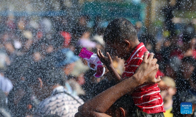 A child plays with a toy water gun during the Thingyan water festival in Yangon, Myanmar, April 14, 2026. (Xinhua/Myo Kyaw Soe)

