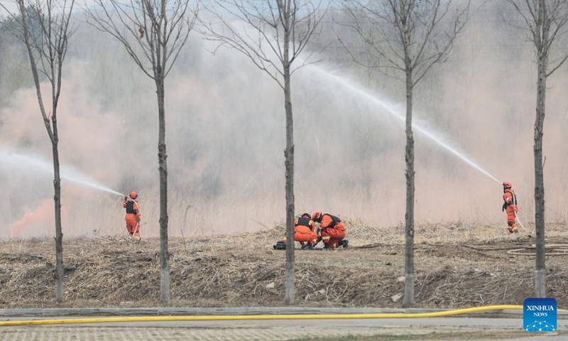 Fire fighters participate in a fire drill in Shenyang, northeast China's Liaoning Province, April 14, 2026. The drill was conducted on Tuesday to enhance the local emergency workers' preparedness for forest fires, which are prone in spring. (Xinhua/Pan Yulong)

