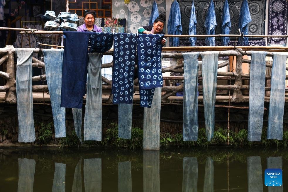 People dry indigo dyed fabrics in Zhaoxing Dong Village of Liping County, southwest China's Guizhou Province, April 21, 2026.

