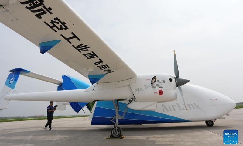A journalist films the HH-200 commercial unmanned aerial transport system which completed its maiden flight in Pucheng, northwest China's Shaanxi Province, April 15, 2026. (Xinhua/Li Yibo)

