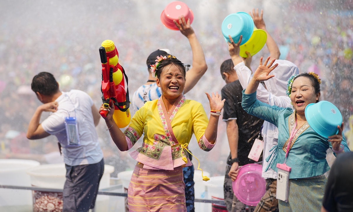 Dai people and tourists sprinkle water to send blessings in celebration of the Water-Splashing Festival in Jinghong, Southwest China's Yunnan Province, on April 15, 2026. During the festival, water is considered an auspicious symbol and people splash water on one another, thereby wishing for happiness and good fortune. Photo: VCG