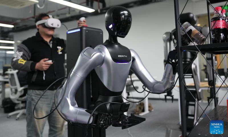 A technician debugs a humanoid robot at a company in Ningbo, east China's Zhejiang Province, March 26, 2026. (Xinhua/Huang Zongzhi)

