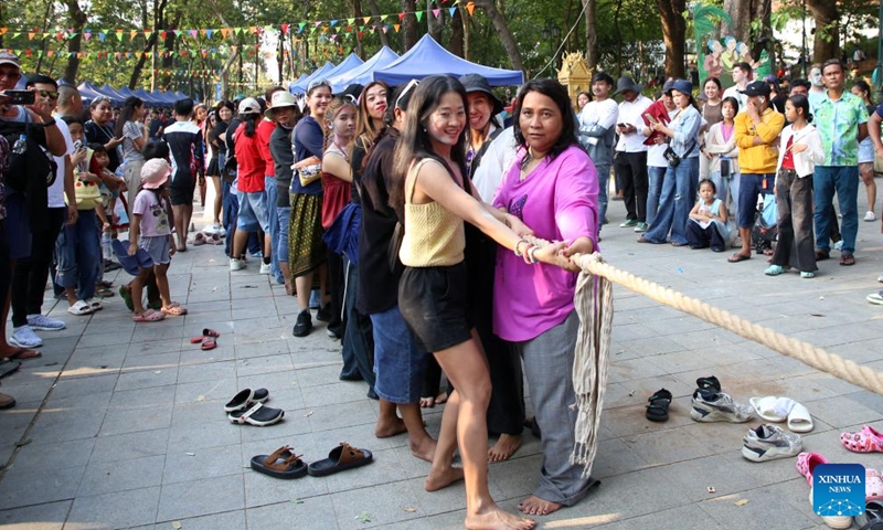 People play tug-of-war game during the celebrations of the Cambodian New Year at the Wat Phnom historical site in Phnom Penh, Cambodia on April 14, 2026. (Photo by Sovannara/Xinhua)

