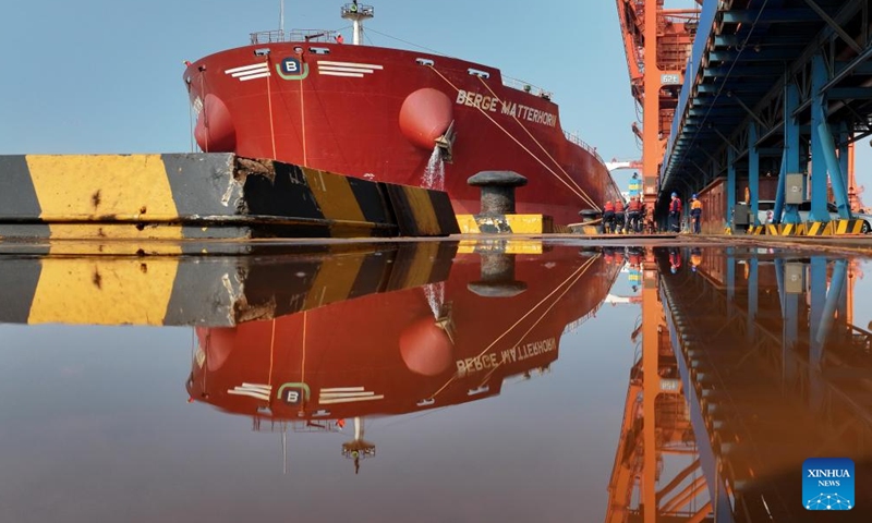 A drone photo taken on April 15, 2026 shows workers preparing a vessel for departure at the ore terminal of Caofeidian Port Area in Tangshan Port in Tangshan, north China's Hebei Province. From January to March this year, Caofeidian Port Area handled a cargo throughput of 138.03 million tonnes, marking a year-on-year increase of 3.16 percent. (Xinhua/Yang Shiyao)

