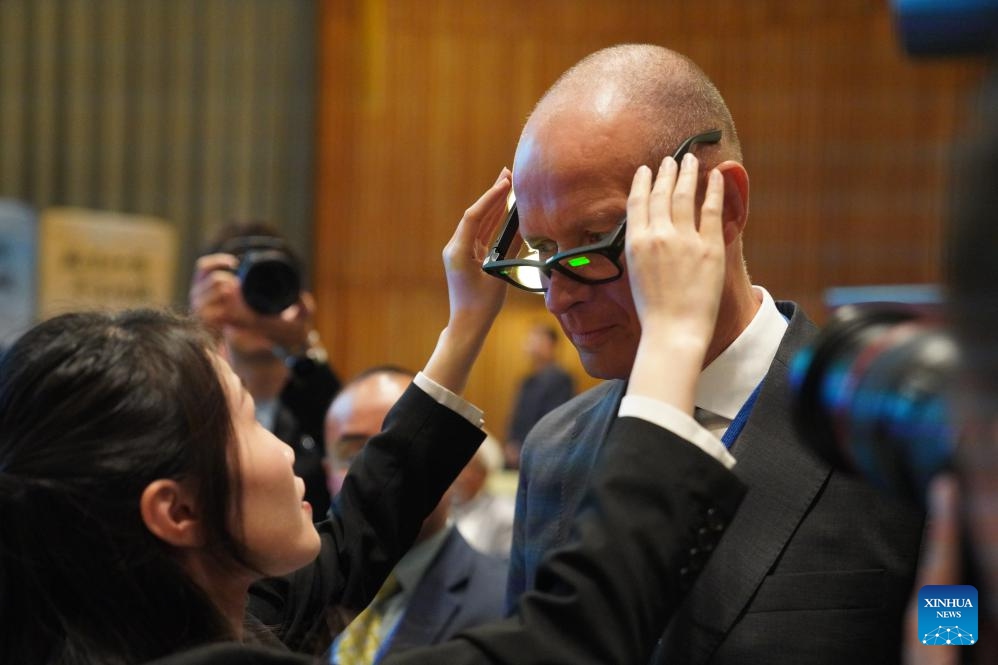 A guest experiences a pair of AI glasses for multimodal translation during a celebration marking the UN Chinese Language Day at the UN headquarters in New York, on April 13, 2026. A celebration titled Chinese Language Shining Civilizations was held at the UN headquarters in New York to mark the UN Chinese Language Day on Monday. (Xinhua/Zhang Fengguo)

