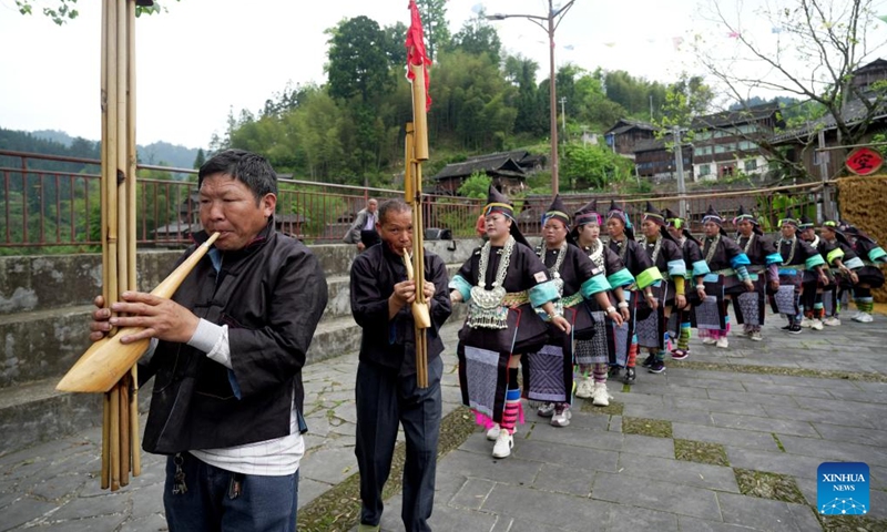 People perform Lusheng, a reed-pipe wind instrument, in an event celebrating the Sanyuesan Festival in Rongjiang County, southwest China's Guizhou Province, April 19, 2026. The Sanyuesan Festival is a traditional festival celebrated on the third day of the third lunar month by various ethnic groups in China, which falls on April 19 this year. (Photo by Wang Bingzhen/Xinhua)

