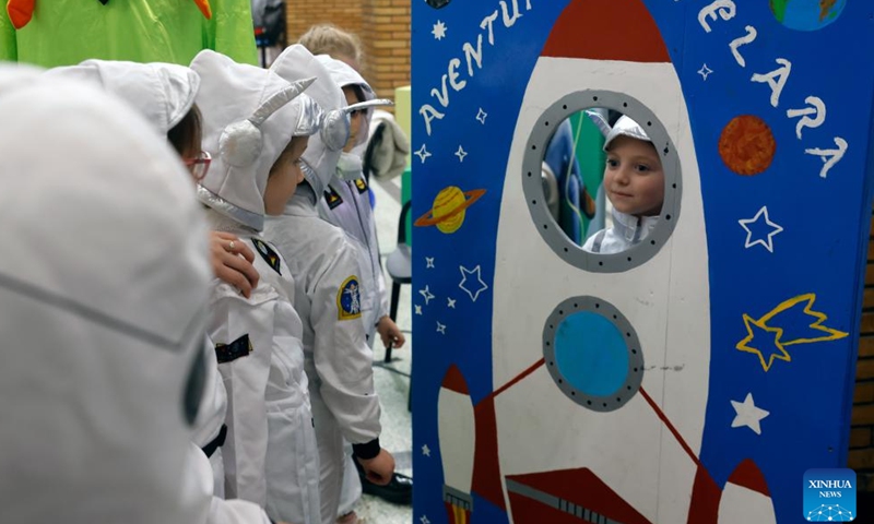 A child poses wearing cosmonaut-like costume during the opening day of Spacefest 2026 at the Politehnica University in Bucharest, Romania, May 7, 2026. The Spacefest is an event dedicated to science, innovation and space exploration, with discussions and presentations about the future of space flight, emerging technologies and collaboration opportunities in the aerospace industry. (Photo by Cristian Cristel/Xinhua)

