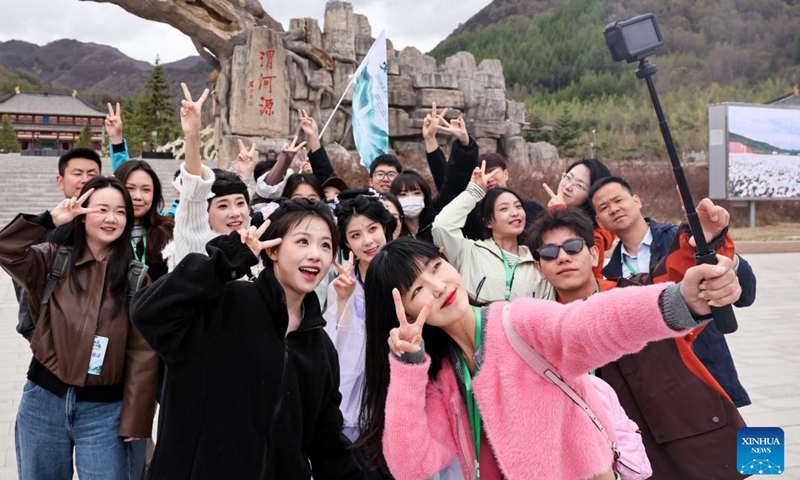 Tourists take selfies at Weiheyuan scenic spot in Dingxi City, northwest China's Gansu Province, April 27, 2026. As the May Day holiday approaches, the tourism markets across the country are heating up. (Photo by Hou Chonghui/Xinhua)

