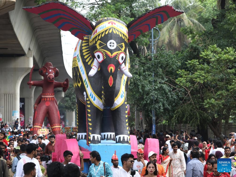 People attend a procession in celebration of the Bengali New Year, known as Pohela Boishakh, in Dhaka, Bangladesh, April 14, 2026. Bangladesh celebrated Bengali New Year 1433 on Tuesday with processions, traditional food and cultural events in the capital Dhaka and elsewhere in the South Asian country. (Photo by Habibur Rahman/Xinhua)

