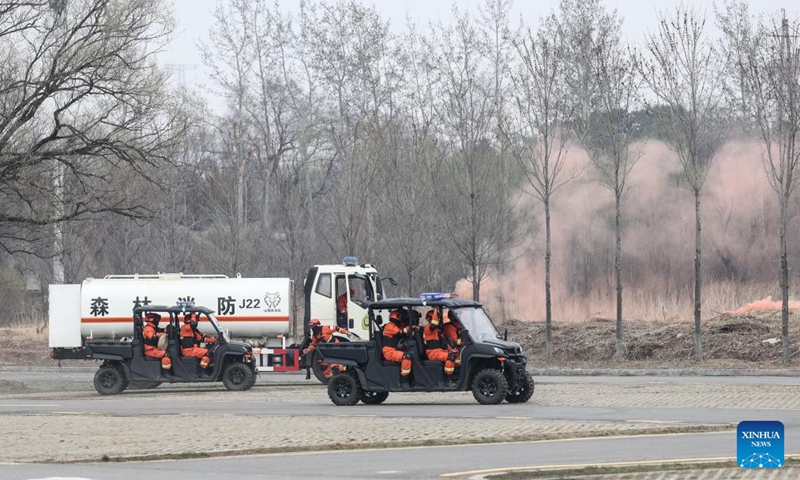 Fire fighters participate in a fire drill in Shenyang, northeast China's Liaoning Province, April 14, 2026. The drill was conducted on Tuesday to enhance the local emergency workers' preparedness for forest fires, which are prone in spring. (Xinhua/Pan Yulong)

