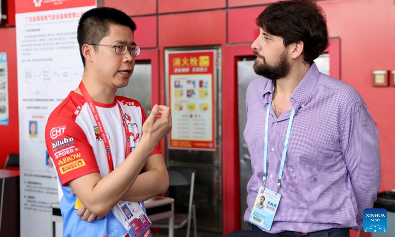 A visitor (R) talks with a staff member of Chinese motorcycle maker ZXMOTO at the 139th edition of the China Import and Export Fair in Guangzhou, south China's Guangdong Province, April 17, 2026. The recent historic double victory by Chinese motorcycle maker ZXMOTO in the World Supersport category at the Portuguese round of the Superbike World Championship has drawn widespread attention. (Xinhua/Lu Hanxin)

