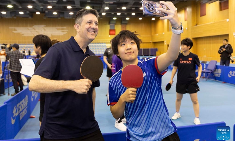 Players of a China-U.S. table tennis friendly match pose for a selfie at Shanghai University of Sport in Shanghai, east China, April 13, 2026. (Xinhua/Wang Xiang)

