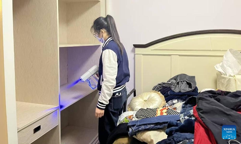 Nai Dan cleans a wardrobe at a client's home in Lanzhou, northwest China's Gansu Province, in April, 2025. (Xinhua)

