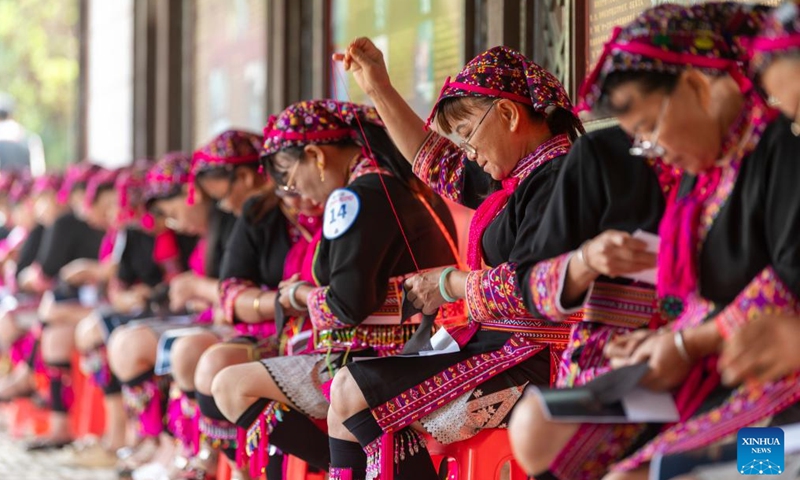 Women take part in a Miao embroidery contest in an event celebrating the Sanyuesan Festival in Qionghai, south China's Hainan Province, April 19, 2026. The Sanyuesan Festival is a traditional festival celebrated on the third day of the third lunar month by various ethnic groups in China, which falls on April 19 this year. (Photo by Meng Zhongde/Xinhua)

