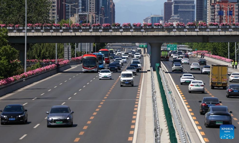 This photo taken on May 7, 2026 shows a road decorated with blooming Chinese roses in Beijing, capital of China. The Chinese roses, one of Beijing's city flowers, have entered their blooming season as early summer arrives in the city. (Xinhua/Ju Huanzong)

