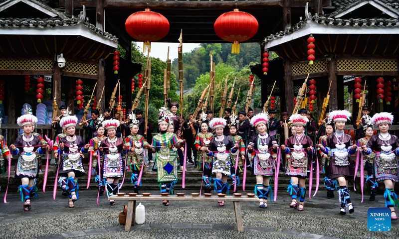 Local residents welcome guests in Zhaoxing Dong Village of Liping County, southwest China's Guizhou Province, March 23, 2026.

